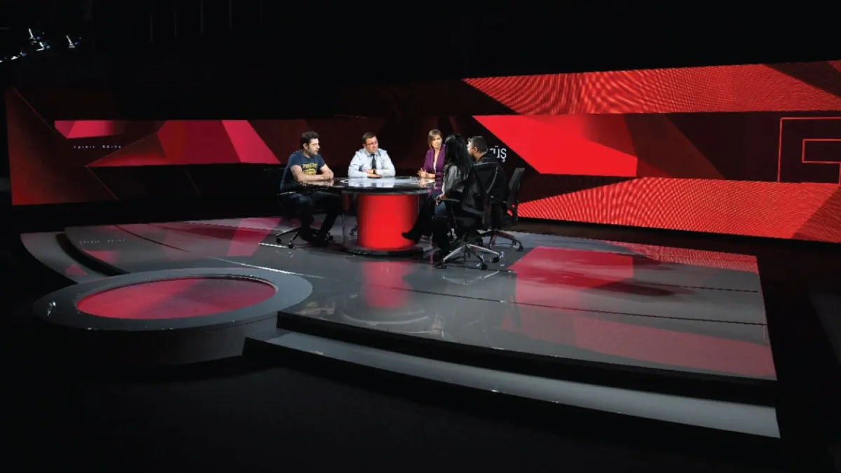 Studio environment used for news presentation: Point of delivering news to viewers. The News Studio incorporates Video Wall Graphic Designs, which consist of multiple screens within the set design. These designs are carefully crafted to ensure compatibility with other graphic elements such as the lower third and opener, creating a cohesive visual experience.